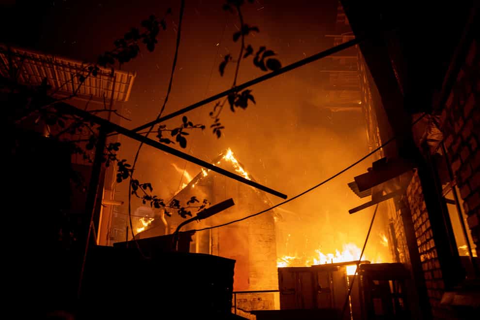 A house burns after a Russian attack in Kherson (Evgeniy Maloletka/AP)