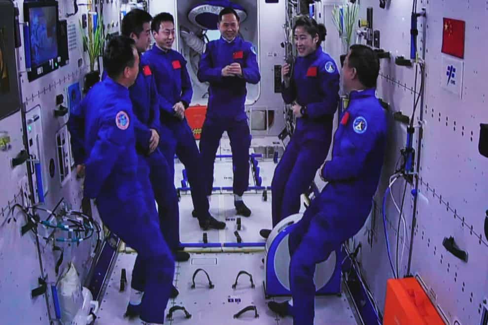 The Shenzhou-15 and Shenzhou-14 crews chatting after a historic gathering in space on Wednesday (Guo Zhongzheng/Xinhua via AP)