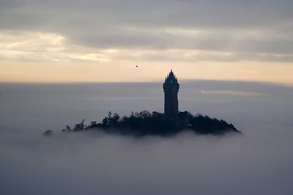 The Wallace Monument sits above heavy fog in Stirling (PA)