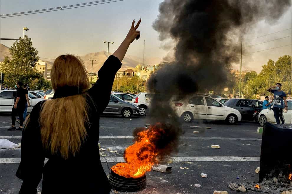 Iranians protest the death of 22-year-old Mahsa Amini after she was detained by the morality police, in Tehran in October (Middle East Images/AP)