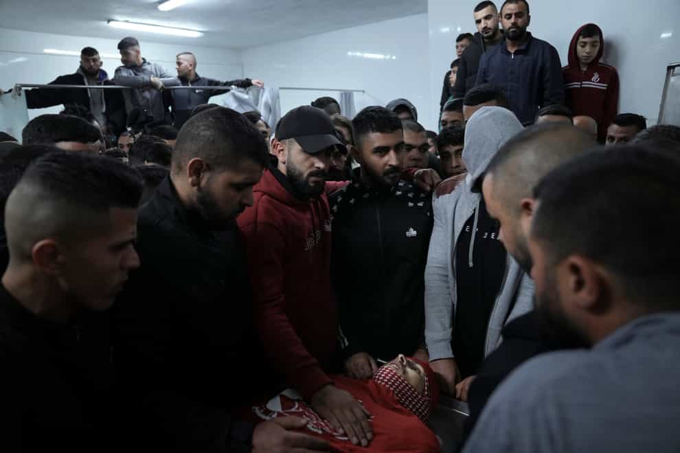 Palestinian mourners gather around the body of Omar Manaa during his funeral in the West Bank refugee camp of Deheishe (Mahmoud Illean/AP)