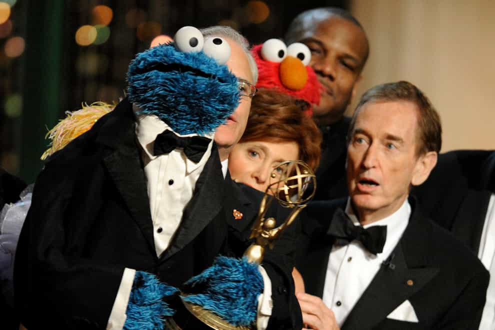 Bob McGrath looks at the Cookie Monster as they accept the Lifetime Achievement Award for Sesame Street at the Daytime Emmy Awards in 2009 (AP)
