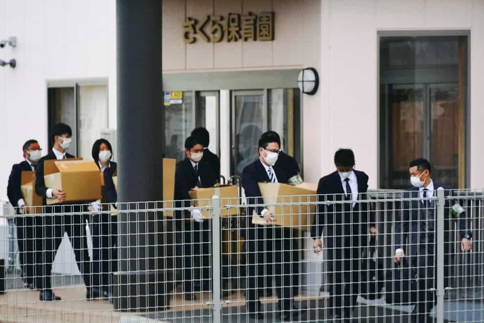 Police investigators carry boxes of documents out of Sakura nursery school in Susono city, Shizuoka, central Japan (Kyodo News/AP)