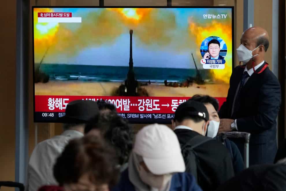 A TV screen shows a file image of North Korea’s military exercise (AP)