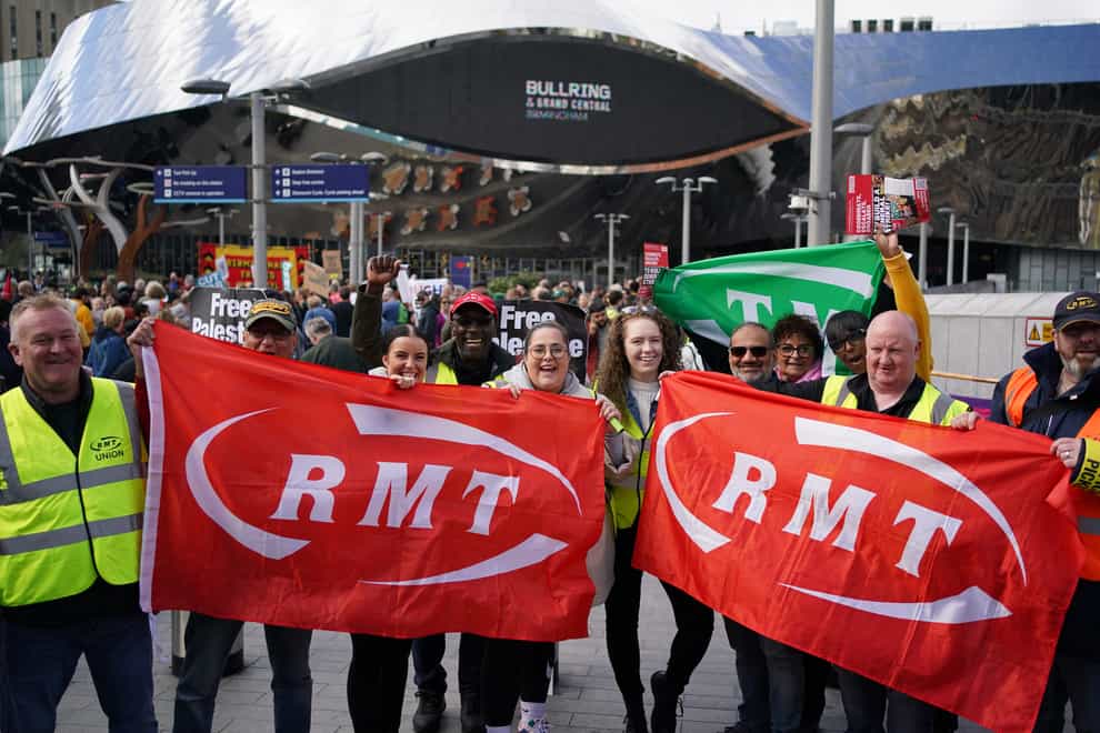 Rail workers on a picket line at Birmingham New Street Station (PA)