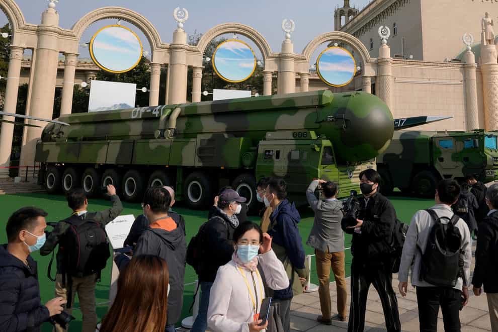 Visitors tour past military vehicles carrying the Dong Feng 41 and DF-17 ballistic missiles (AP)