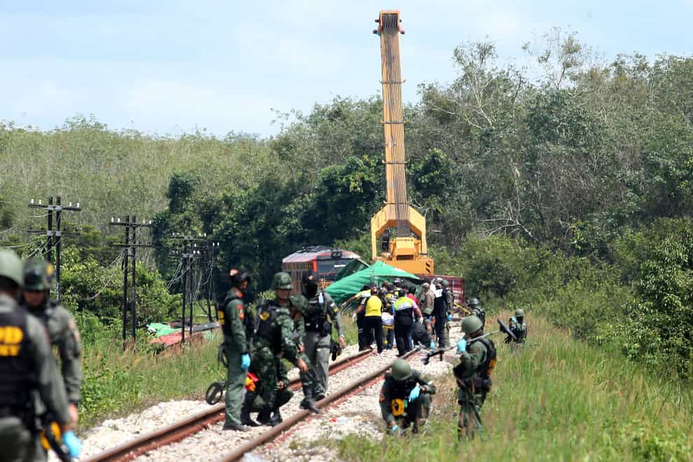 Officers examine a section of track damaged by a bomb blast in Songkhla province, southern Thailand (AP)