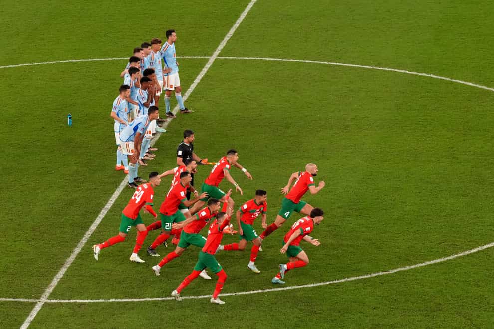 Morocco players celebrate winning the penalty shoot-out over Spain (Nick Potts/PA)