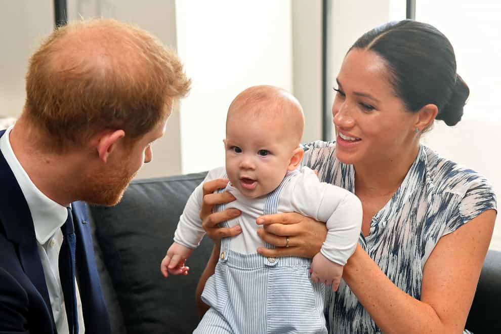 The Duke and Duchess of Sussex holding their son Archie during a meeting with Archbishop Desmond Tutu and Mrs Tutu at their legacy foundation in cape Town in August 2022 (Toby Melville/PA)