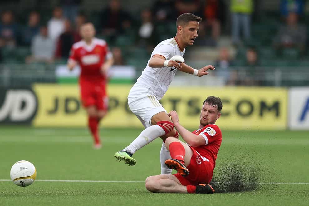 Newtown’s Jake Thomas Walker (right) during Europa Conference League tie against Spartak Trnava in July. The Welsh Premier play-offs are set to take place on the day of the King’s coronation on May 6 (Barrington Coombs/PA)