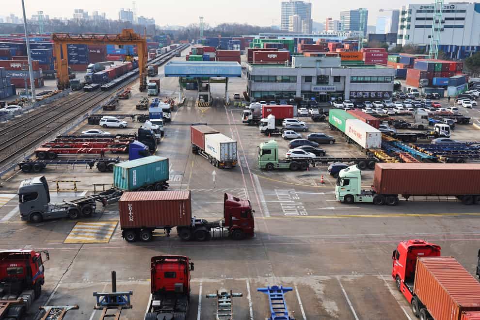 Container trucks run at the Inland Container Depot in Uiwang (Yonhap via AP)
