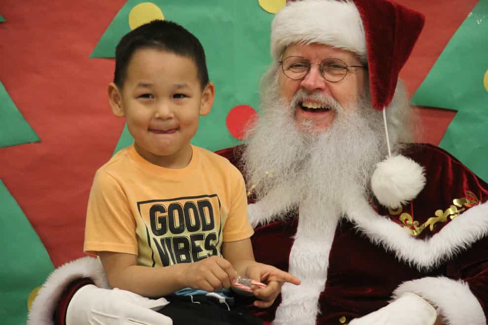 Santa Claus poses with a child at the Trapper School in Nuiqsut, Alaska (AP)