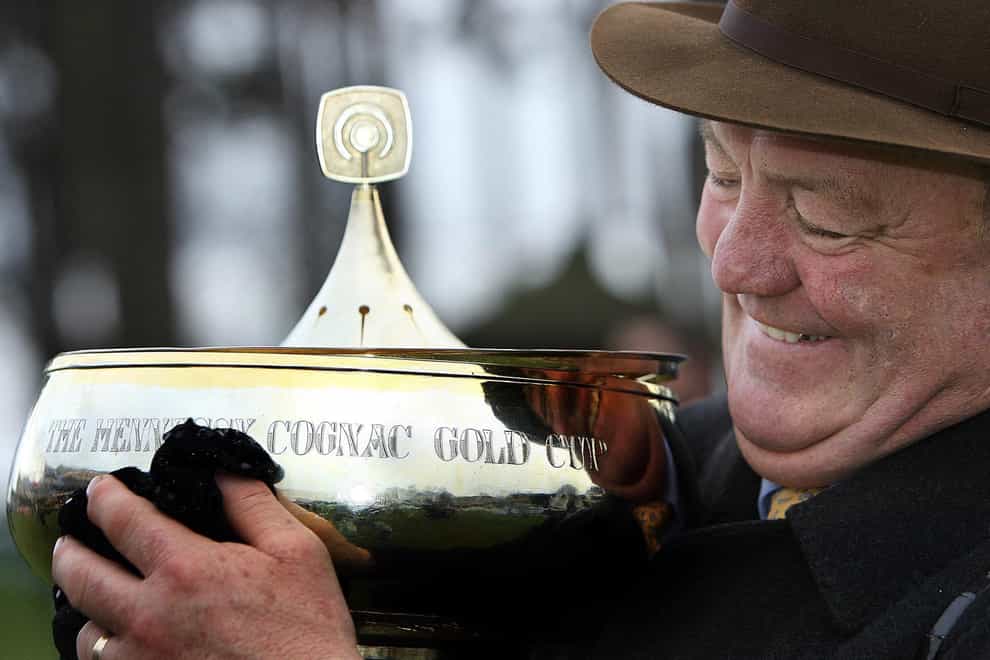 Beef or Salmon winning trainer Michael Hourigan polishes the Hennessy Cognac Gold Cup at Leopardstown racecourse, Dublin (Julian Behal/PA)