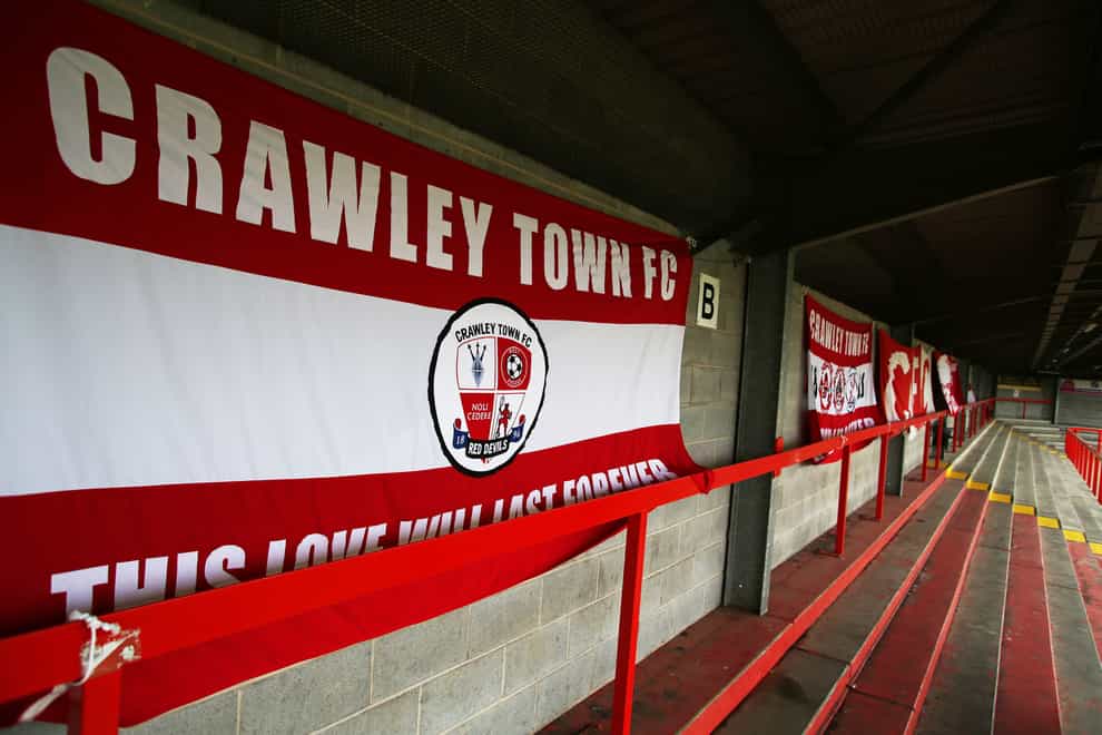 A general view of Crawley Town flags attached to an empty terrace inside the ground before the Sky Bet League Two match at The People’s Pension Stadium, Crawley.