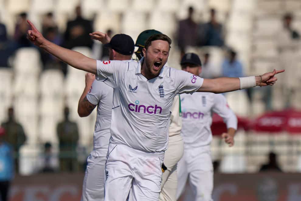 Ollie Robinson celebrates taking the final wicket (Anjum Naveed/AP)