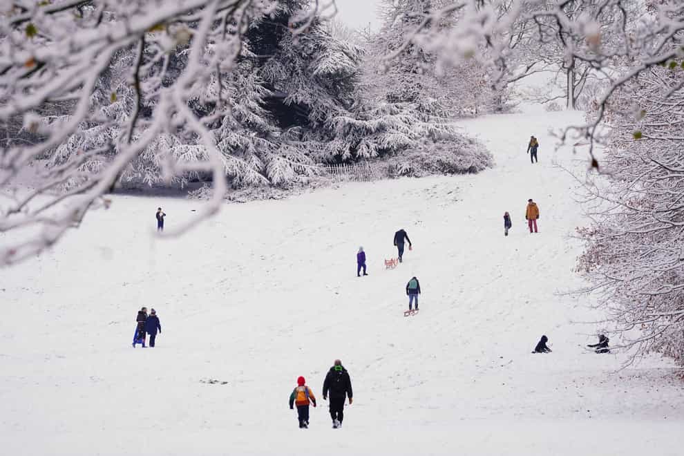 People walk through the snow in Greenwich Park, London (Victoria Jones/PA)