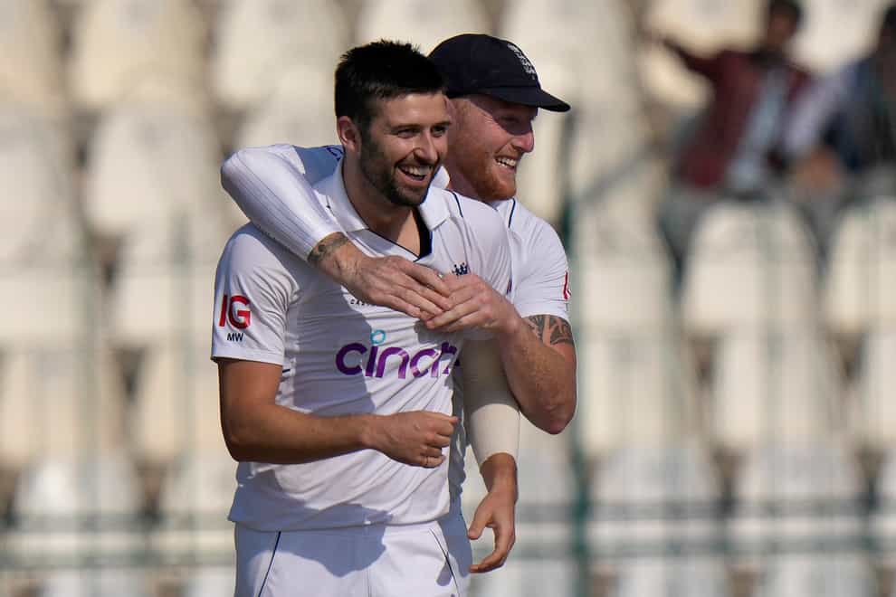 Mark Wood, left, celebrates with England captain Ben Stokes after the dismissal of Pakistan’s Saud Shakeel en route to England’s second Test win in Multan (Anjum Naveed/AP)