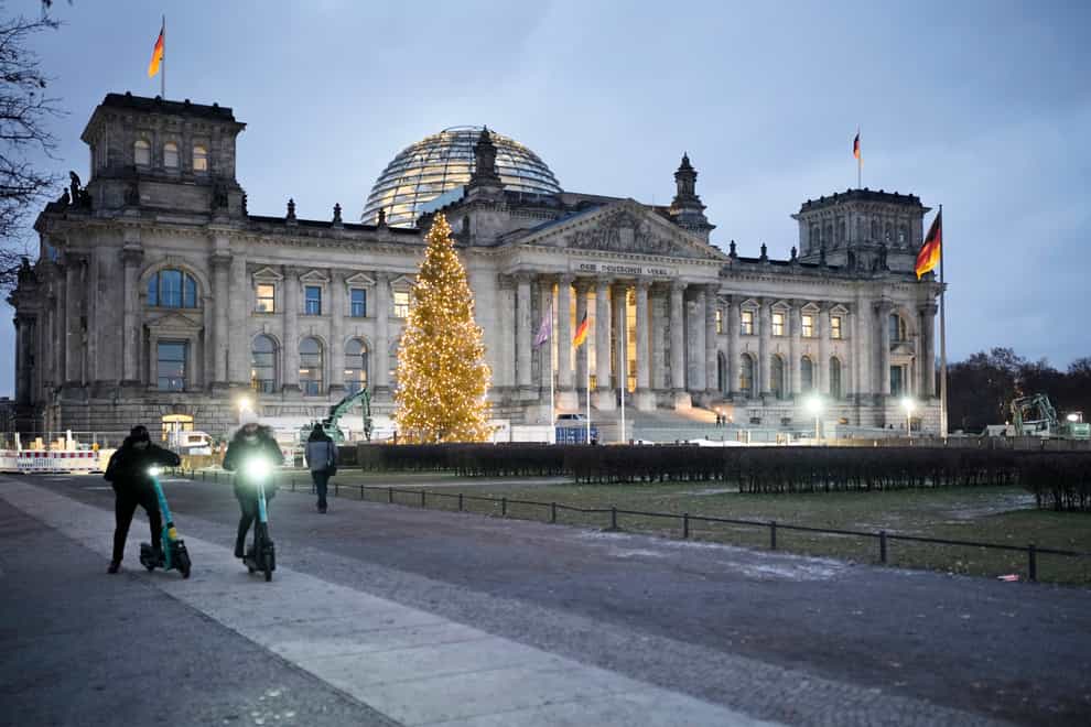 The Reichstag building with the German Parliament Bundestag is illuminated in Berlin, Germany (Markus Schreiber/AP)