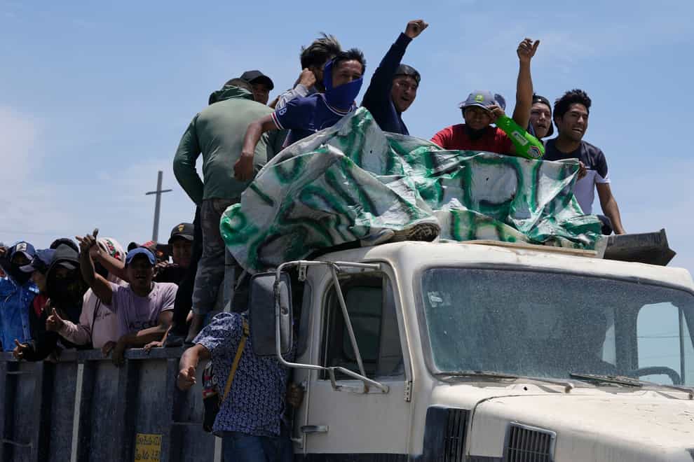Supporters of ousted Peruvian President Pedro Castillo arrive in a truck to help block the Pan-American South Highway in Ica, Peru (Martin Mejia/AP/PA)