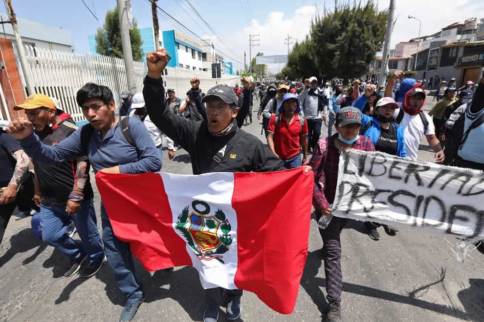 Supporters of ousted Peruvian President Pedro Castillo protest against his detention in Arequipa, Peru (Fredy Salcedo/AP/PA)