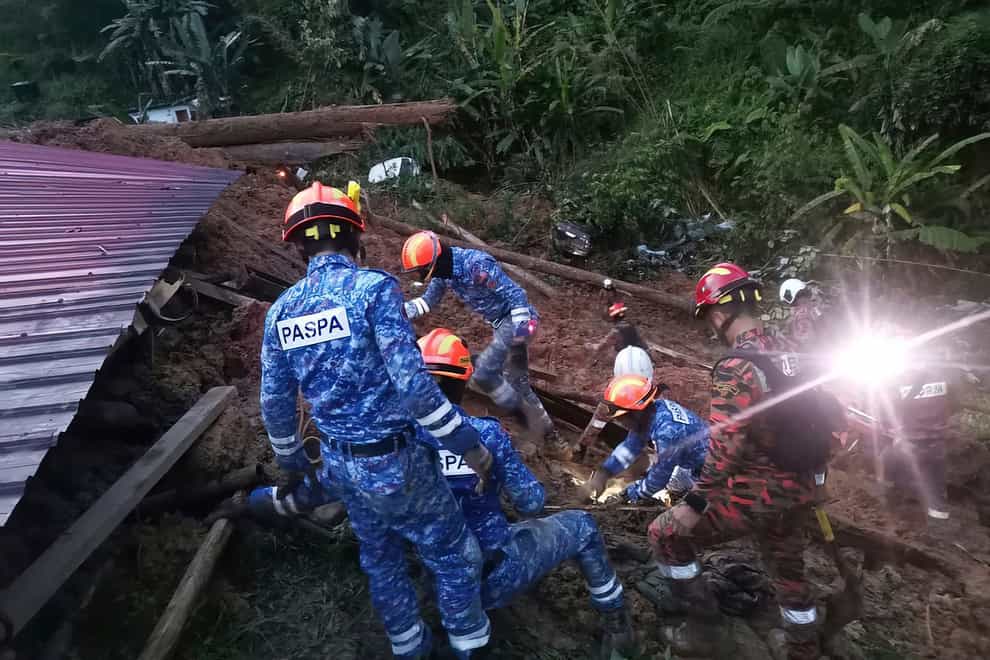 More than 50 people are feared buried alive after a landslide hit a campsite outside Kuala Lumpur early on Friday, Malaysia’s fire department has said (Malaysia Civil Defence/AP )