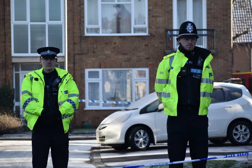 Police officers at the scene in Kettering, Northamptonshire where a woman and two children were murdered. Officers were called to Petherton Court at around 11.15am on Thursday where they found the woman and a boy and girl, with serious injuries. The woman died at the scene despite treatment from paramedics and the two children died later in hospital. A man has been arrested on suspicion of murder following the deaths. Picture date: Friday December 16, 2022.