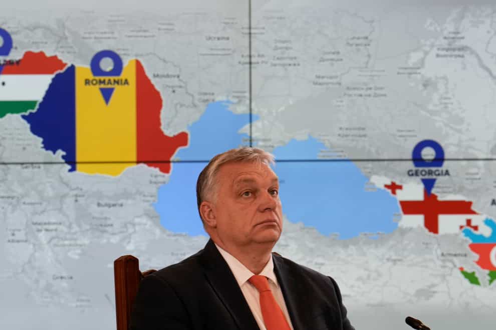 Hungarian prime minister Viktor Orban with a screen showing the countries that signed a strategic energy partnership (Vadim Ghirda/AP)