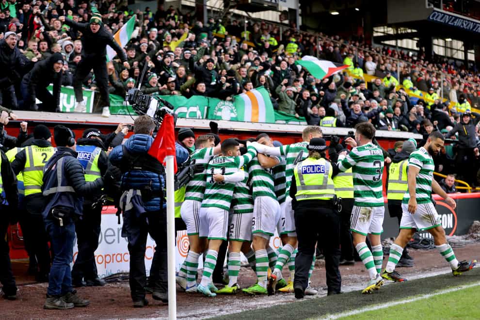 Celtic players celebrate after Callum McGregor’s late winner (Steve Welsh/PA)