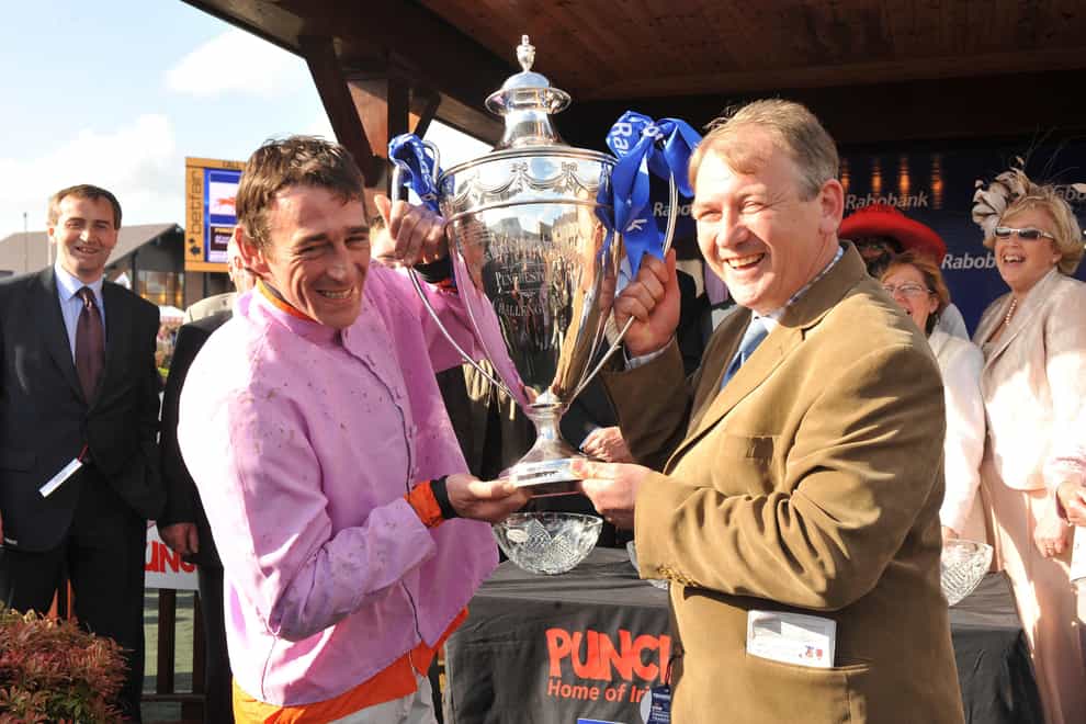 Jockey Davy Russell (left) and Trainer Charles Byrne with the cup after Solwhit had won the Rabobank Champion Hurdle during the Punchestown Racing Festival at Punchestown Racecourse, Ireland (Damien Eagers/PA)