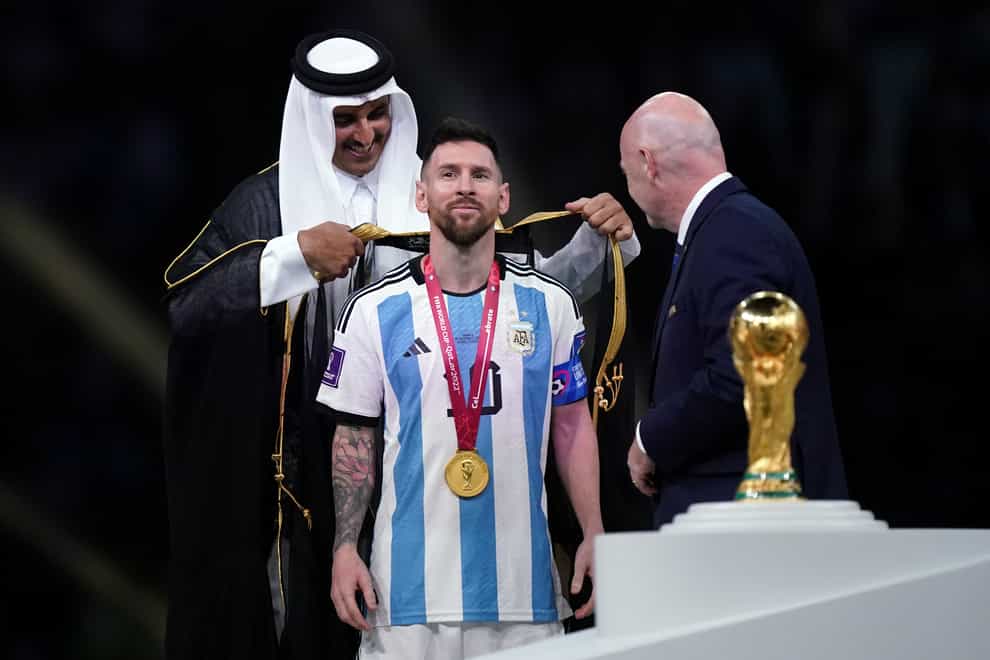 Emir of Qatar, Sheikh Tamim bin Hamad Al Thani dresses Argentina’s Lionel Messi with traditional Arab bisht ahead of the World Cup trophy presentation