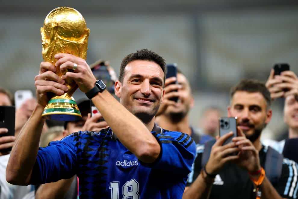 Argentina manager Lionel Scaloni celebrates with the World Cup trophy (Nick Potts/PA)