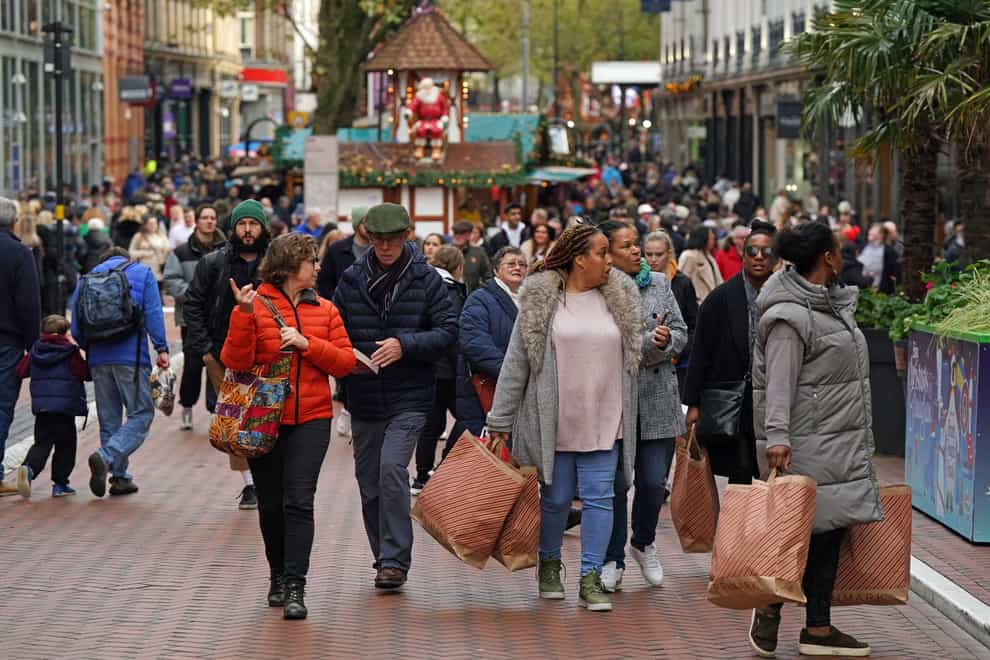 Shoppers on New Street in Birmingham do some Christmas shopping (PA)