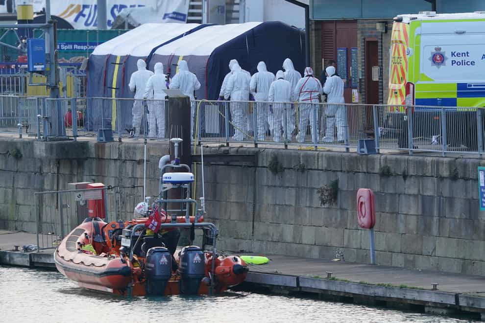 Forensic officers head to the forensic tents erected at the RNLI station at the Port of Dover (Gareth Fuller/PA)
