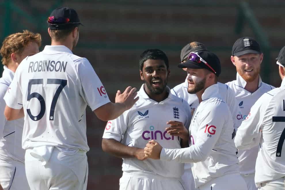 Rehan Ahmed, centre, celebrates a wicket with his England team-mates (Fareed Khan/PA)