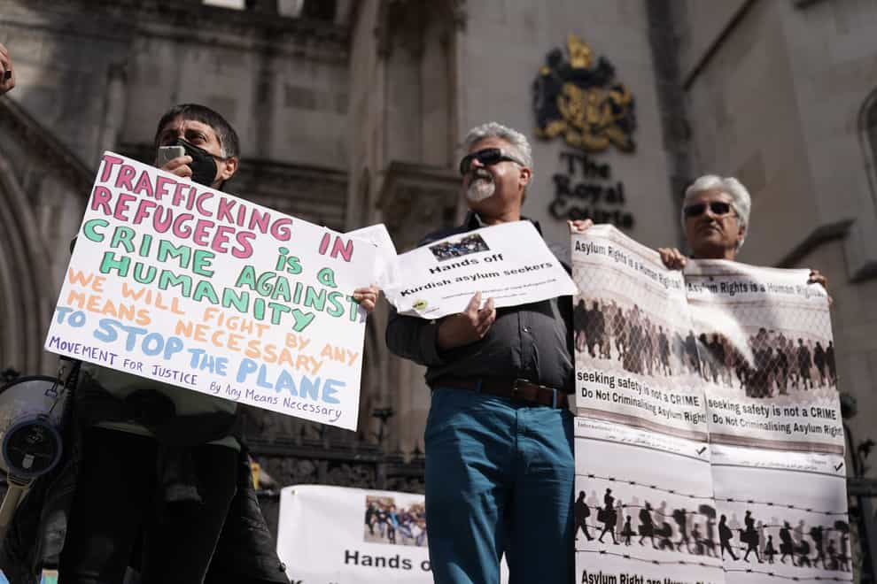 Protesters outside the High Court in London for the ruling on Rwanda deportation flights. Charities and campaigners supporting migrants are appealing against a High Court ruling on Friday which paved the way for the first deportation flight to take place on Tuesday. Picture date: Monday June 13, 2022.