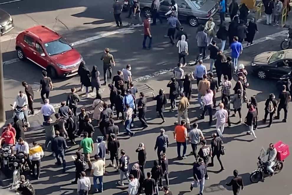 People block an intersection during a protest to mark 40 days since the death in custody of 22-year-old Mahsa Amini. Belgium is urging its nationals to leave Iran and warns that they face the risk of arrest, arbitrary detention or unfair trial (AP/PA)
