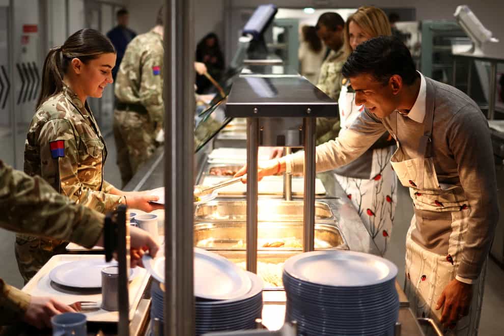 Prime Minister Rishi Sunak serves Christmas dinner to troops at the Tapa military base in Estonia (Henry Nicholls/PA)