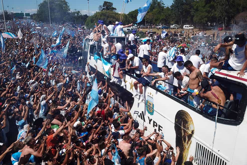 Football fans welcome home the Argentine soccer team after it won the World Cup (Victor Caivano/AP/PA)
