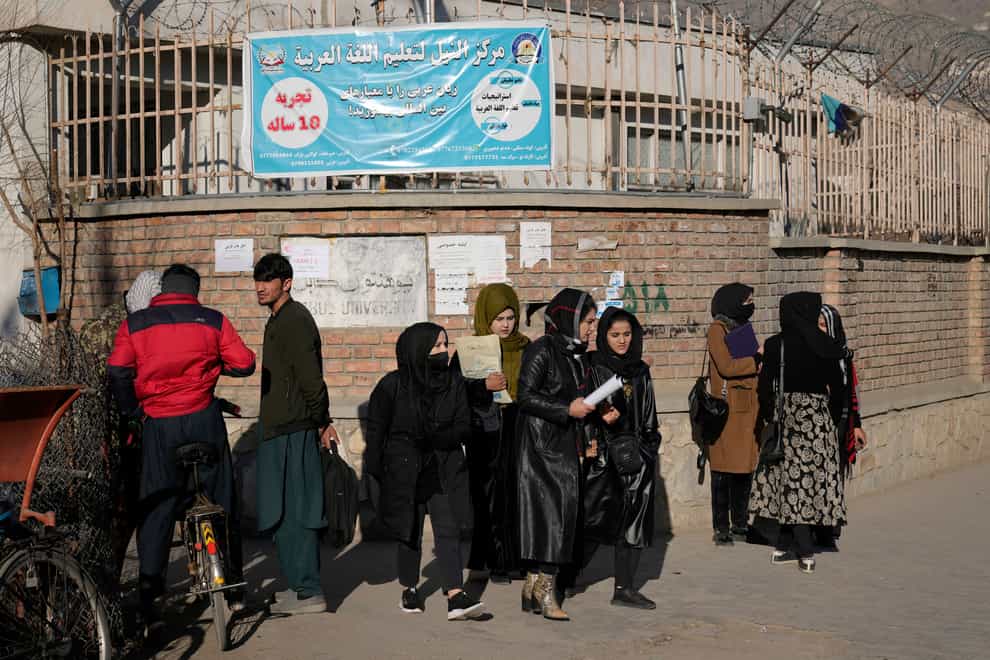 Afghan women students stand outside Kabul University, Afghanistan, on Wednesday December 21 2022 (Ebrahim Noroozi/AP)