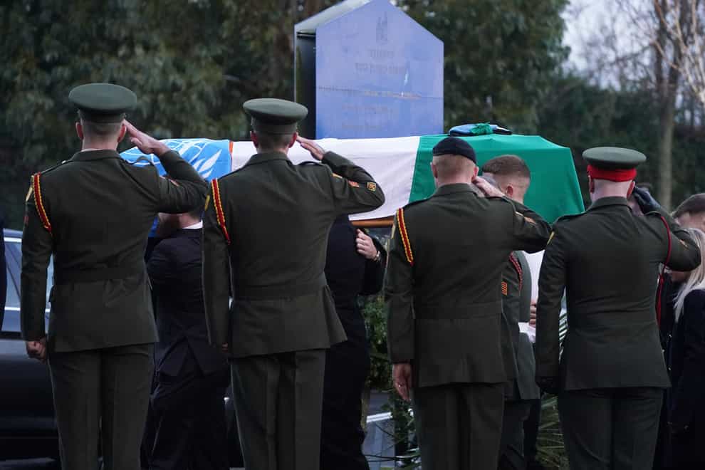 Members of the Irish Defence Forces salute as the coffin of Private Sean Rooney is carried into Holy Family Church, Dundalk, Co Louth for his funeral mass. Pte Rooney, 23, from Newtowncunningham in Co Donegal, was serving with a UN peacekeeping mission, when his convoy came under attack in Lebanon (Brian Lawless/PA Wire)