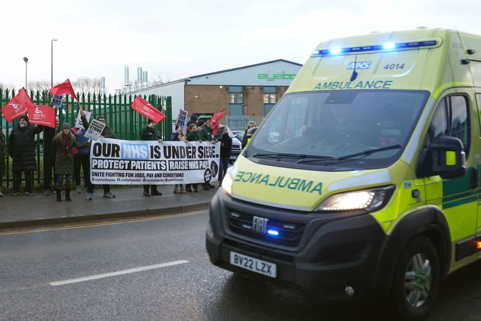 Ambulance workers on the picket line outside ambulance headquarters in Coventry (PA)