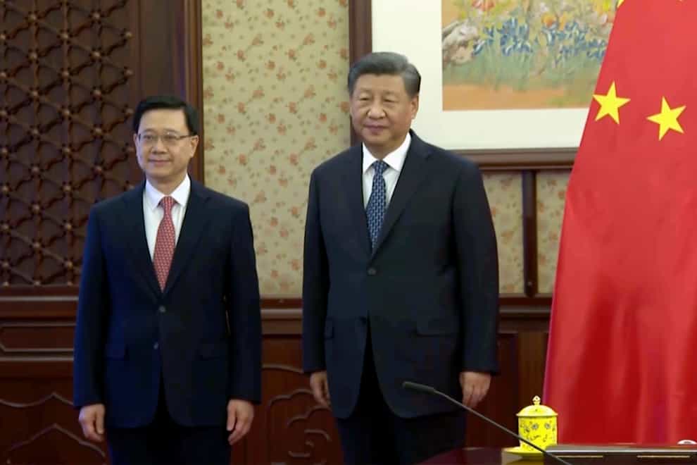 Hong Kong Chief Executive John Lee and Chinese President Xi Jinping (Pool via AP)