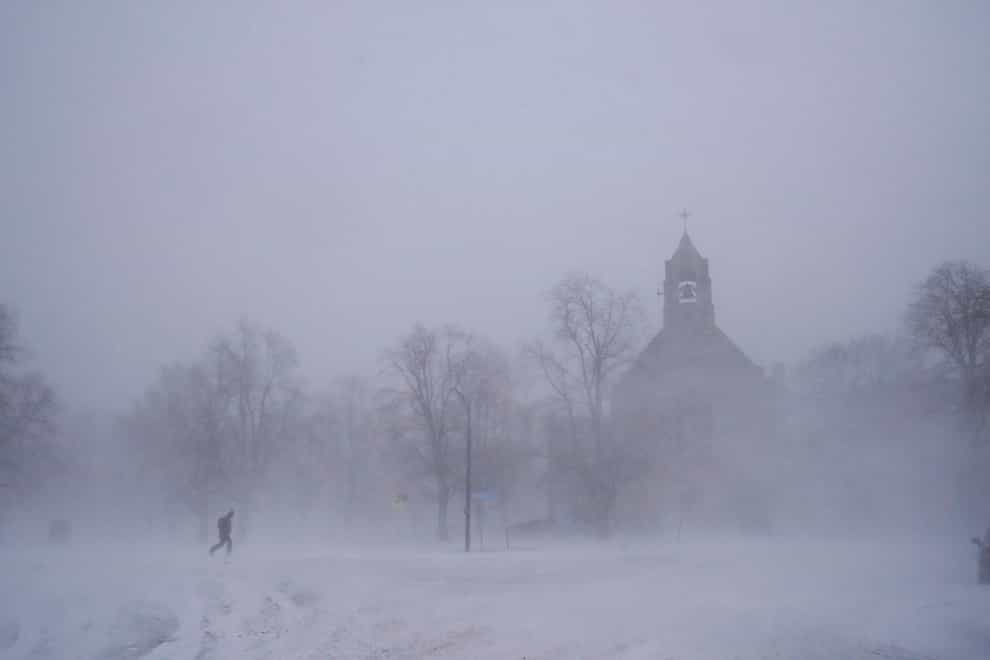 A lone pedestrian makes his way across Colonial Circle in Buffalo, New York (Derek Gee/The Buffalo News/AP)