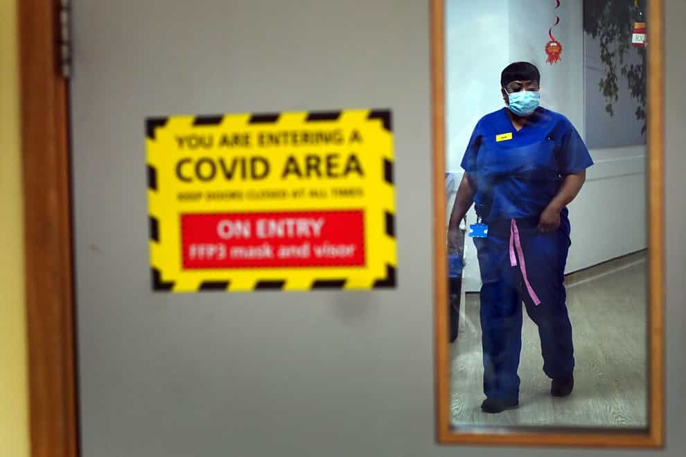 A nurse walks through a covid ward at King’s College Hospital, in south east London (Victoria Jones/PA)