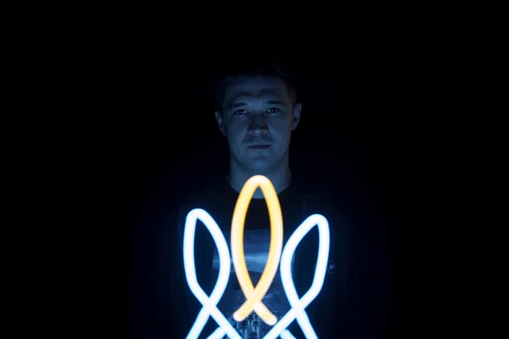 Mykhailo Fedorov, Ukrainian minister of digital transformation, poses for a photo illuminated by a lamp in the shape of a Ukrainian trident, a national symbol, in his office in Kyiv, Ukraine (Felipe Dana/AP/PA)