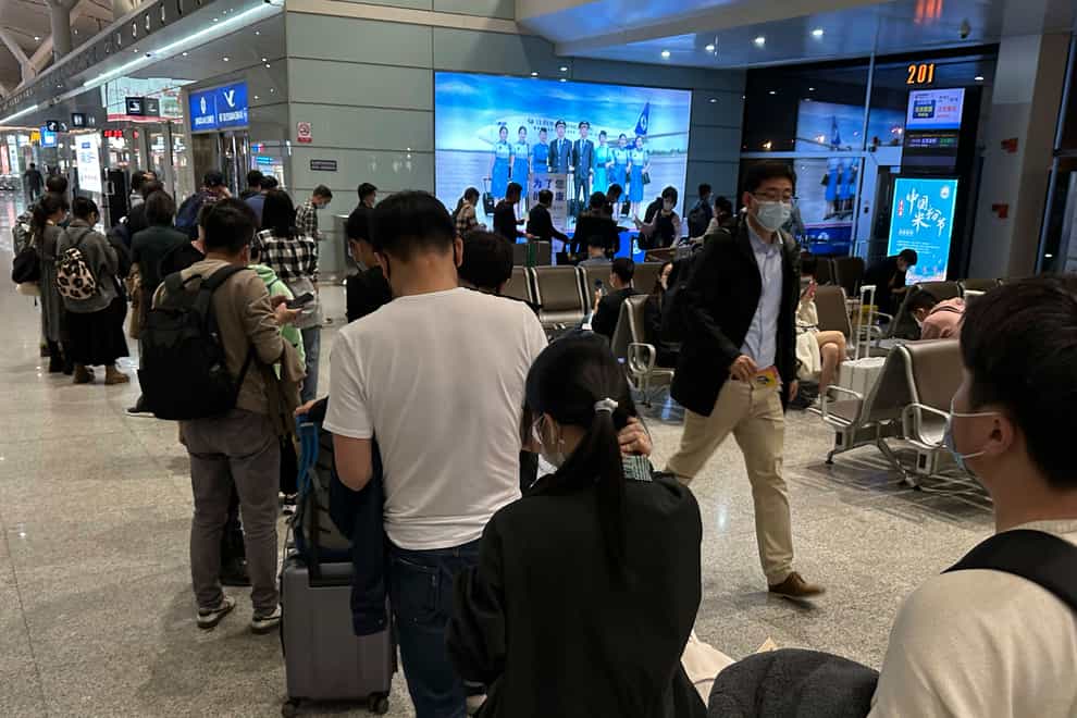 Passengers prepare to board a flight at the airport in north-central China’s Jiangxi province (Ng Han Guan/AP/PA)