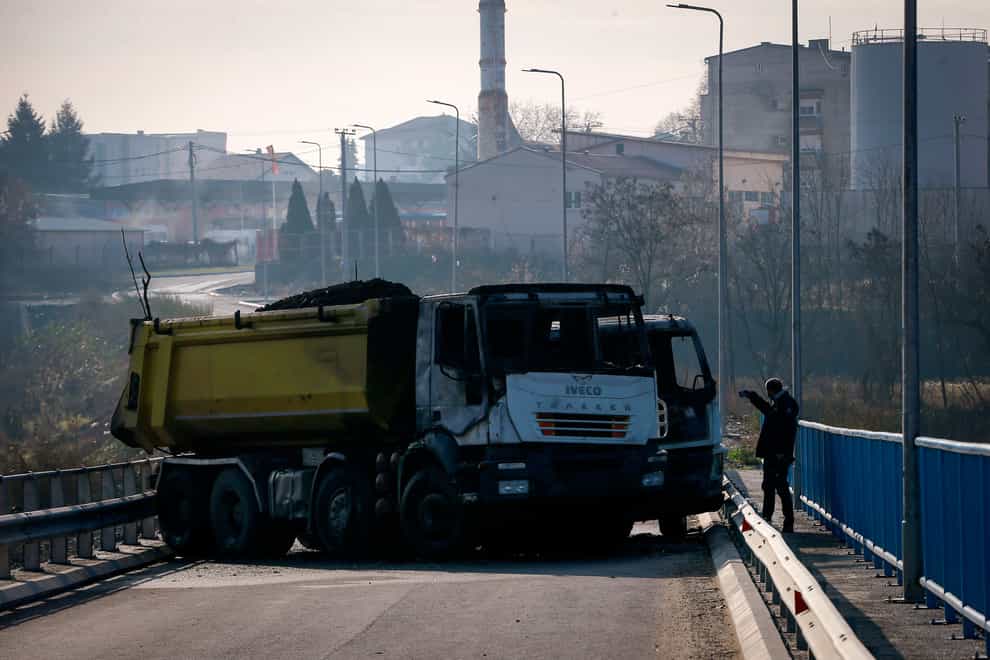 A burnt-out truck is part of a barricade on the bridge near the northern, Serb-dominated part of Mitrovica, Kosovo (Visar Kryeziu/AP)