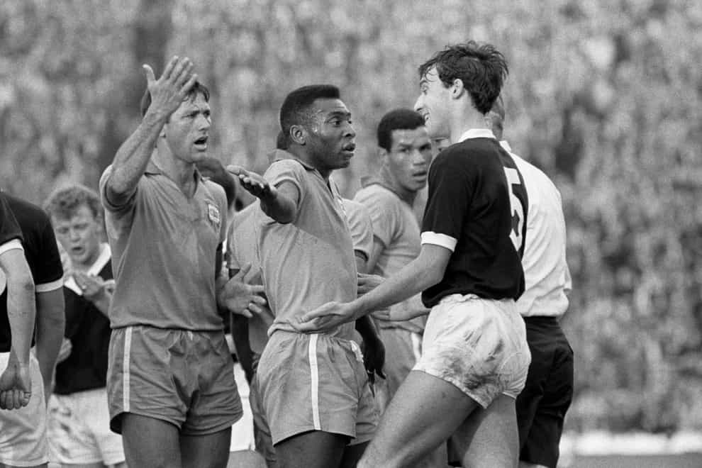 Pele remonstrates with Scotland’s Ronnie MacKinnon following a clash with Billy Bremner (PA)