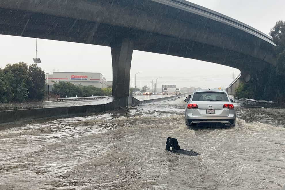 Traffic drives through flooded lanes on Highway 101 in South San Francisco, California (AP)