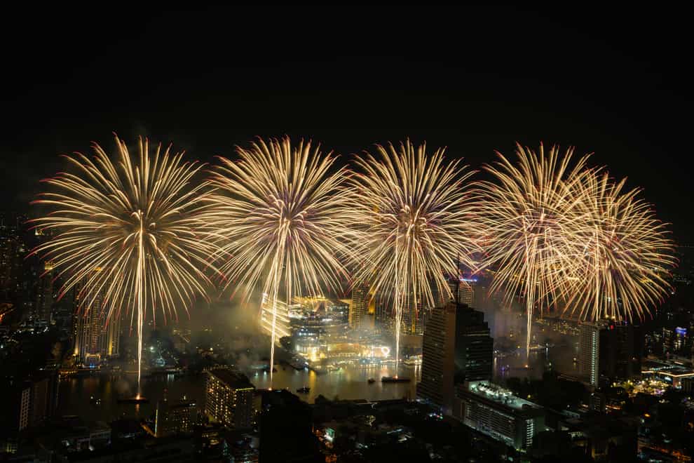 Fireworks explode over the Chao Phraya River during New Year celebrations in Bangkok, Thailand (AP)
